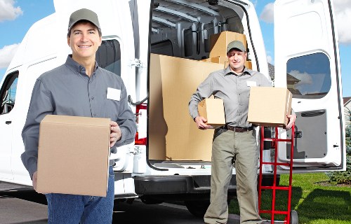 Local movers preparing fragile household items for transport