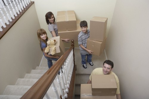 Professional movers securing furniture in an Edgware van